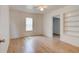 Bright bedroom features wood-look flooring, a ceiling fan, and a window for natural light at 514 Mary Ave, New Smyrna Beach, FL 32168