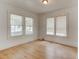 Bright bedroom with wood-look floors and three windows for natural light at 514 Mary Ave, New Smyrna Beach, FL 32168