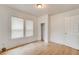 Bright bedroom features wood-look floors, a closet, and multiple windows at 514 Mary Ave, New Smyrna Beach, FL 32168