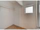 Walk-in closet with wood-look floors and small window for natural light at 514 Mary Ave, New Smyrna Beach, FL 32168