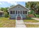 Charming single-story home with gray stone, a screened-in porch, and a well-manicured front lawn at 514 Mary Ave, New Smyrna Beach, FL 32168