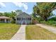 Charming single Gathering home with a sidewalk leading to a cozy screened front porch at 514 Mary Ave, New Smyrna Beach, FL 32168
