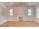 Bright and airy living room featuring hardwood floors, white walls, and a cozy decorative fireplace at 514 Mary Ave, New Smyrna Beach, FL 32168