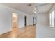 Spacious open-concept living area with hardwood floors, white walls, and easy access to other rooms at 514 Mary Ave, New Smyrna Beach, FL 32168