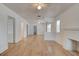 Spacious open-plan living room featuring white walls, hardwood floors, and abundant natural light at 514 Mary Ave, New Smyrna Beach, FL 32168