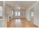 Bright living room featuring hardwood floors, white walls, a charming fireplace, and ample natural light at 514 Mary Ave, New Smyrna Beach, FL 32168