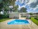 Large backyard featuring a pool surrounded by greenery, providing a private outdoor space at 5476 W Bayshore Dr, Port Orange, FL 32127