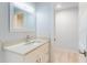 Bright bathroom featuring a white vanity, modern fixtures, and a hall entrance at 5476 W Bayshore Dr, Port Orange, FL 32127