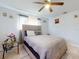 Comfortable bedroom featuring a neutral headboard and a ceiling fan at 5476 W Bayshore Dr, Port Orange, FL 32127