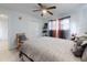 Comfortable bedroom featuring a neutral headboard and a ceiling fan at 5476 W Bayshore Dr, Port Orange, FL 32127
