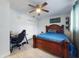 Bright bedroom with a ceiling fan, a desk, and a stylish wooden bed frame at 5476 W Bayshore Dr, Port Orange, FL 32127