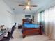 Bedroom with wooden bed frame, ceiling fan, and light colored flooring at 5476 W Bayshore Dr, Port Orange, FL 32127