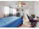 Bedroom with wooden bed frame, ceiling fan, and light colored flooring at 5476 W Bayshore Dr, Port Orange, FL 32127