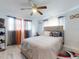 Comfortable bedroom featuring a neutral headboard and a ceiling fan at 5476 W Bayshore Dr, Port Orange, FL 32127