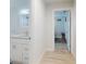 Hallway with bathroom featuring modern vanity with granite counters at 5476 W Bayshore Dr, Port Orange, FL 32127