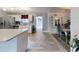 Open concept kitchen with stainless steel appliances, white cabinets, and a breakfast bar at 5476 W Bayshore Dr, Port Orange, FL 32127