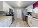 Modern kitchen featuring stainless steel appliances, white cabinetry, and stylish backsplash at 5476 W Bayshore Dr, Port Orange, FL 32127