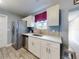 Bright kitchen with stainless steel appliances, white cabinetry, and modern backsplash at 5476 W Bayshore Dr, Port Orange, FL 32127