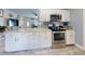 Well-appointed kitchen featuring stainless steel appliances, white cabinets, and modern countertops at 5476 W Bayshore Dr, Port Orange, FL 32127