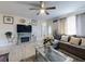 Spacious living room with an electric fireplace, comfortable sectional, and modern finishes at 5476 W Bayshore Dr, Port Orange, FL 32127