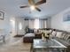 Cozy living room with neutral tones, a plush sectional, and open entry at 5476 W Bayshore Dr, Port Orange, FL 32127