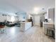 Spacious living room connects to kitchen with island and hardwood floors at 5476 W Bayshore Dr, Port Orange, FL 32127