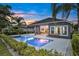 A backyard with a pristine pool surrounded by lush greenery, ideal for relaxation at 6294 W Fallsgrove Ln, Port Orange, FL 32128