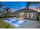Backyard view of pool, covered patio with dining set and exterior of the home at 6294 W Fallsgrove Ln, Port Orange, FL 32128