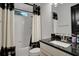 Cozy bathroom features a bathtub shower combo, dark countertops and a modern vanity at 6294 W Fallsgrove Ln, Port Orange, FL 32128