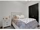 Comfortable bedroom featuring a double closet, bedside table, and a cozy, inviting atmosphere at 6294 W Fallsgrove Ln, Port Orange, FL 32128