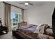 Cozy bedroom with a large window, dresser, soft textures and plenty of natural light at 6294 W Fallsgrove Ln, Port Orange, FL 32128