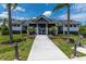 Exterior view of the modern community clubhouse with a walkway, landscaping, and bike rack at 6294 W Fallsgrove Ln, Port Orange, FL 32128