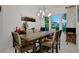 Cozy dining room bathed in natural light with a glimpse of lush backyard at 6294 W Fallsgrove Ln, Port Orange, FL 32128