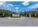 Community entrance with landscaped signage, black metal gates, and well-maintained surroundings, creating a welcoming atmosphere at 6294 W Fallsgrove Ln, Port Orange, FL 32128