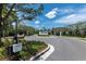 Community entrance features black metal gates, landscaped signage, and a secure entry system for residents and guests at 6294 W Fallsgrove Ln, Port Orange, FL 32128