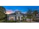 Stunning home featuring stone accents, a well-manicured lawn, and a spacious garage at 6294 W Fallsgrove Ln, Port Orange, FL 32128