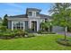 Landscaped home featuring a two-car garage and beautifully manicured front yard at 6294 W Fallsgrove Ln, Port Orange, FL 32128