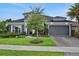 Beautifully landscaped home with a two-car garage and inviting front yard at 6294 W Fallsgrove Ln, Port Orange, FL 32128