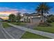 Home exterior featuring a beautifully landscaped front yard and a two-car garage at 6294 W Fallsgrove Ln, Port Orange, FL 32128