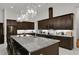 Spacious kitchen boasts granite countertops and dark wood cabinets with a large island at 6294 W Fallsgrove Ln, Port Orange, FL 32128
