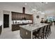 Stylish kitchen features a center island, granite countertops, and ample dark-wood cabinetry at 6294 W Fallsgrove Ln, Port Orange, FL 32128