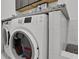 Laundry room featuring modern washer and dryer units with a granite countertop and storage at 6294 W Fallsgrove Ln, Port Orange, FL 32128