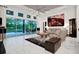 Bright living room boasts marble floors, a modern ceiling fan, and a wall of glass doors to the outdoor dining area at 6294 W Fallsgrove Ln, Port Orange, FL 32128