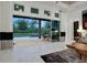 Living room with large sliding doors to the outdoor dining and pool area at 6294 W Fallsgrove Ln, Port Orange, FL 32128
