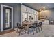 Covered outdoor dining area with a glimpse of living spaces through glass sliding doors at 6294 W Fallsgrove Ln, Port Orange, FL 32128