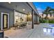 A covered patio with outdoor dining area, a built-in grill, and views of the pool at 6294 W Fallsgrove Ln, Port Orange, FL 32128