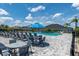Community pool featuring ample seating, clear blue water, and umbrellas for a relaxing outdoor experience at 6294 W Fallsgrove Ln, Port Orange, FL 32128