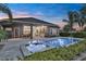 An inviting backyard featuring a shimmering pool and spa with an outdoor dining and entertainment area at 6294 W Fallsgrove Ln, Port Orange, FL 32128
