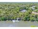 Aerial view of the property with waterfront dock and lush green surroundings at 6325 Palmas Bay Cir, Port Orange, FL 32127