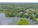 Overhead view showcasing the waterfront property surrounded by dense, lush trees at 6325 Palmas Bay Cir, Port Orange, FL 32127